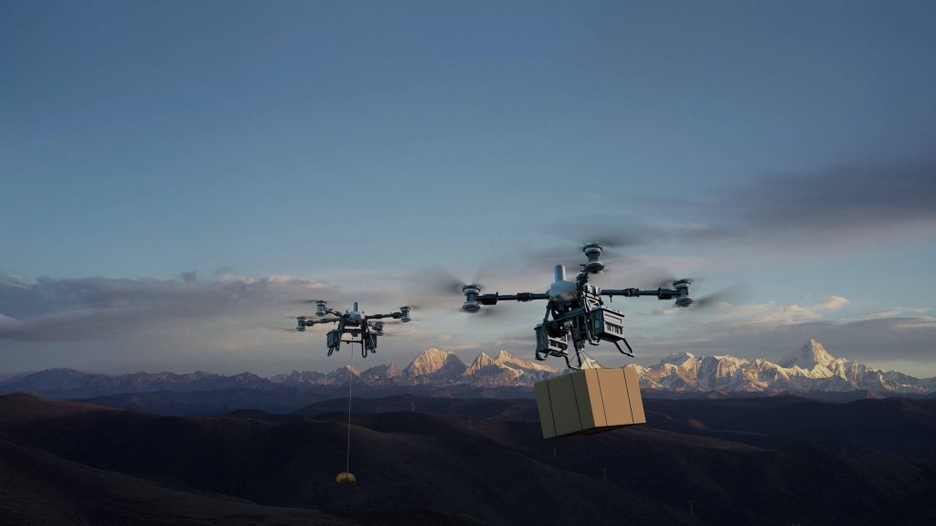 Dos DJI FlyCart 100 transportando cargas diferentes sobre montañas